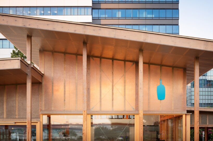 cluster of intimate wooden huts shape blue bottle café in tokyo park