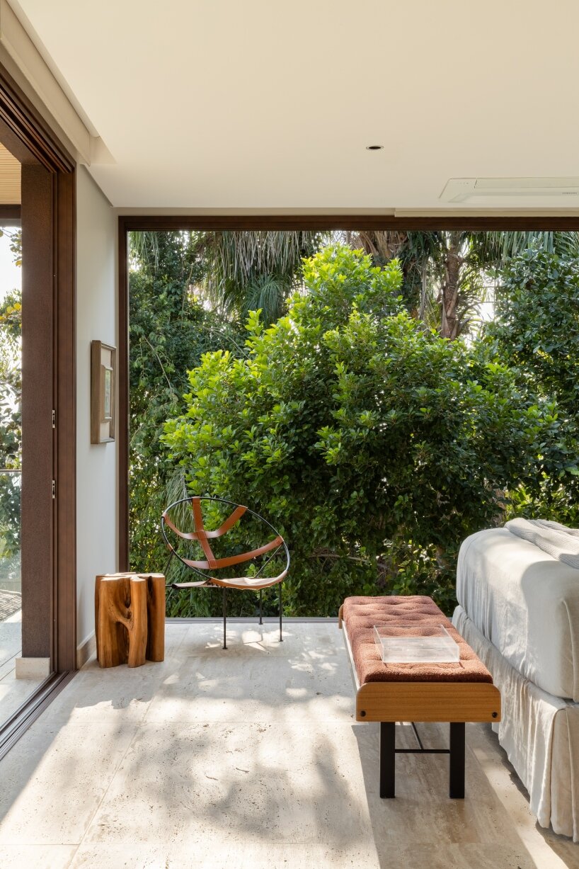 FCstudio's coastal house stacks steel, glass, & stone layers amid são paulo's rugged terrain