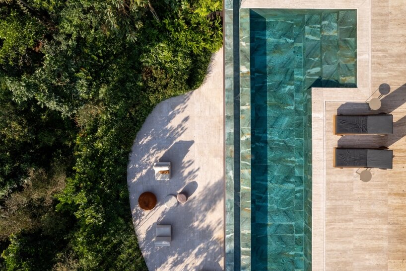 FCstudio's coastal house stacks steel, glass, & stone layers amid são paulo's rugged terrain