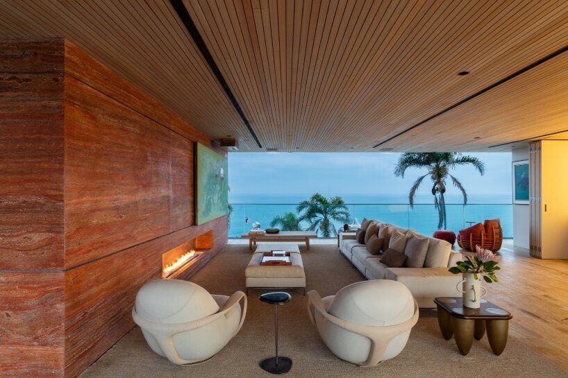 FCstudio's coastal house stacks steel, glass, & stone layers amid são paulo's rugged terrain