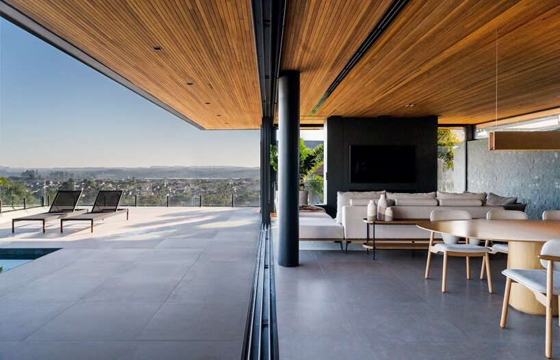 with the glass panels completely open, the interior and exterior dissolve into a single area