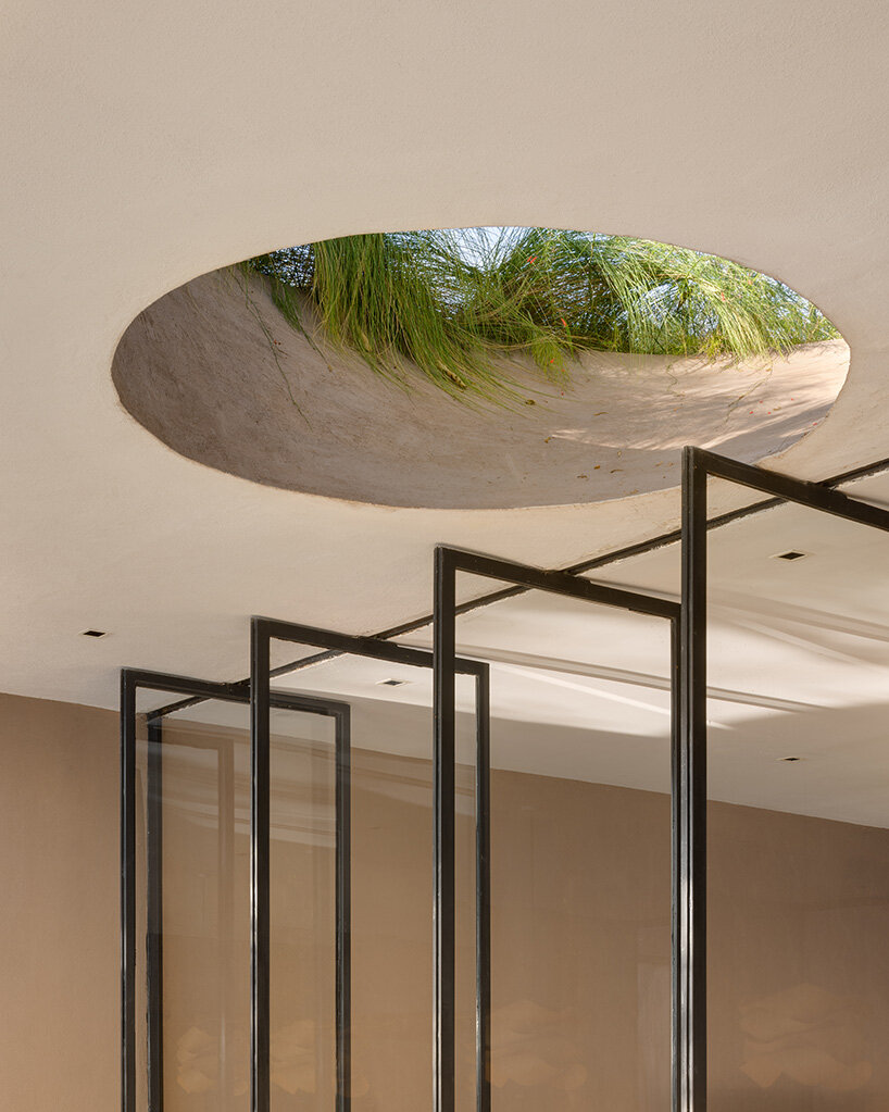 a green roof provides insulation and merges the building into its verdant setting