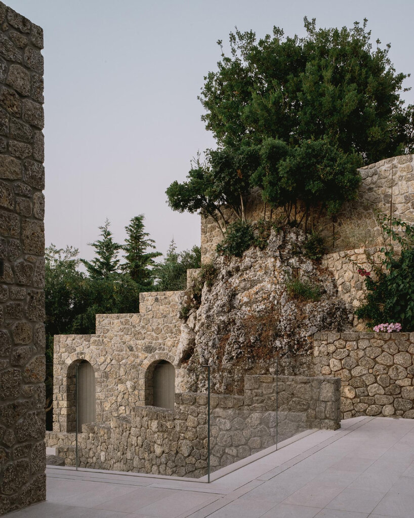 wrapped in stone, corfu house by georgios apostolopoulos overlooks the sea in greece