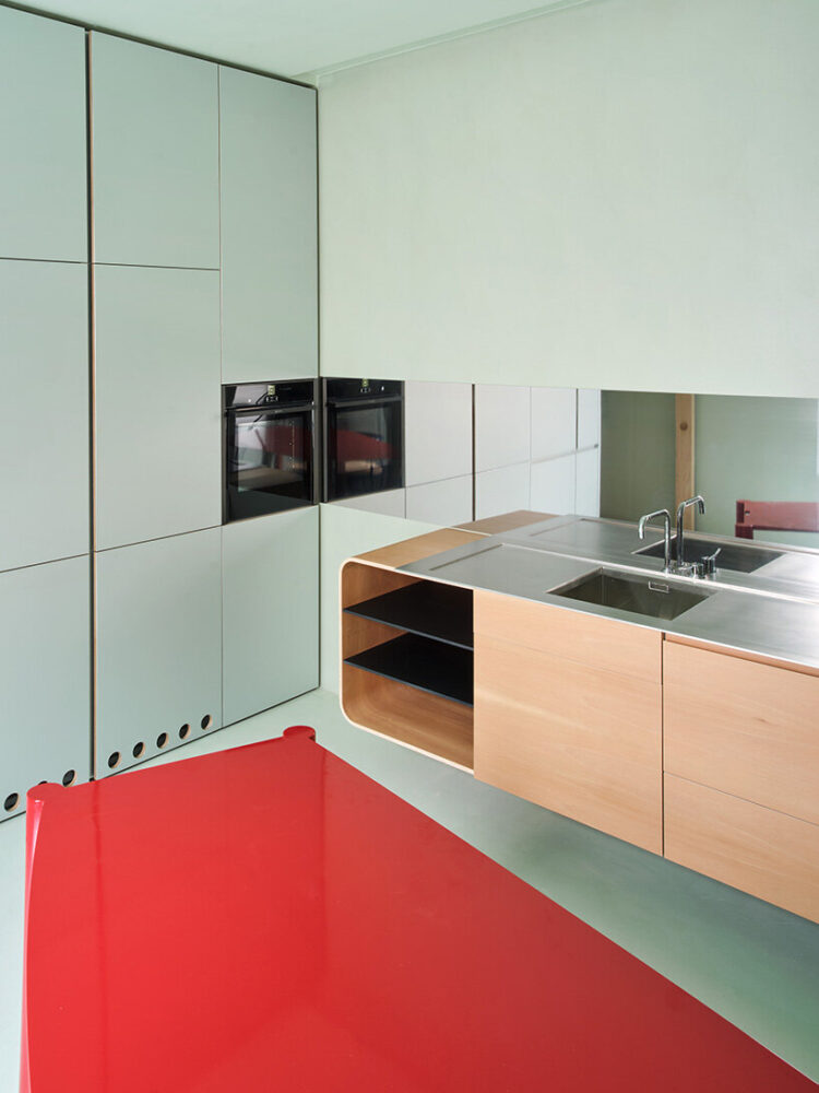 bright red contrasts with the mint-colored surroundings