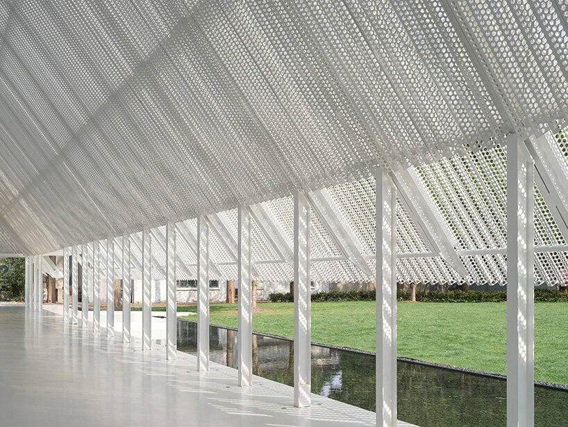 focusing attention on the surrounding natural landscape of trees, bamboo, and water features