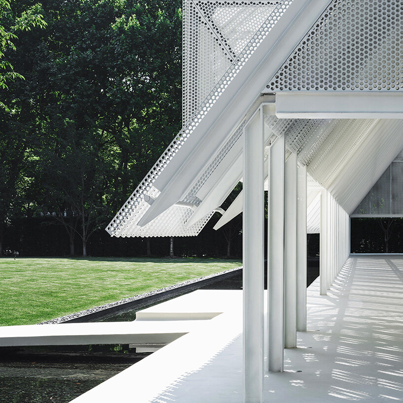 the base of the pavilion transitions into steps, benches, a bridge, and a waterside platform | image by DONG Image