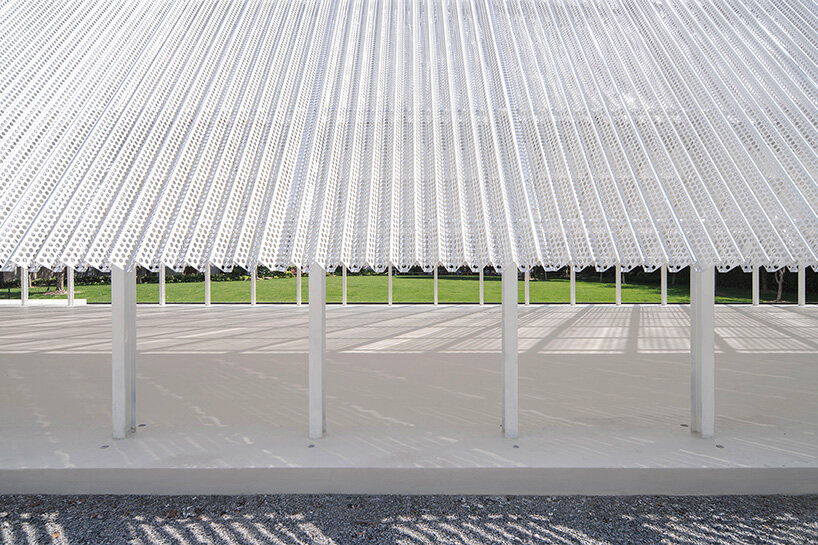 a pool at the base reflects its surroundings, with rainwater collected for reuse | image by DONG Image
