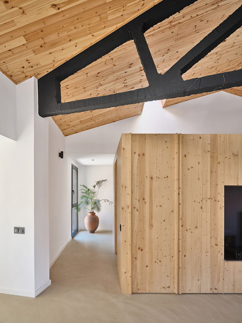 a pinewood mezzanine accommodates a bathroom and dressing area
