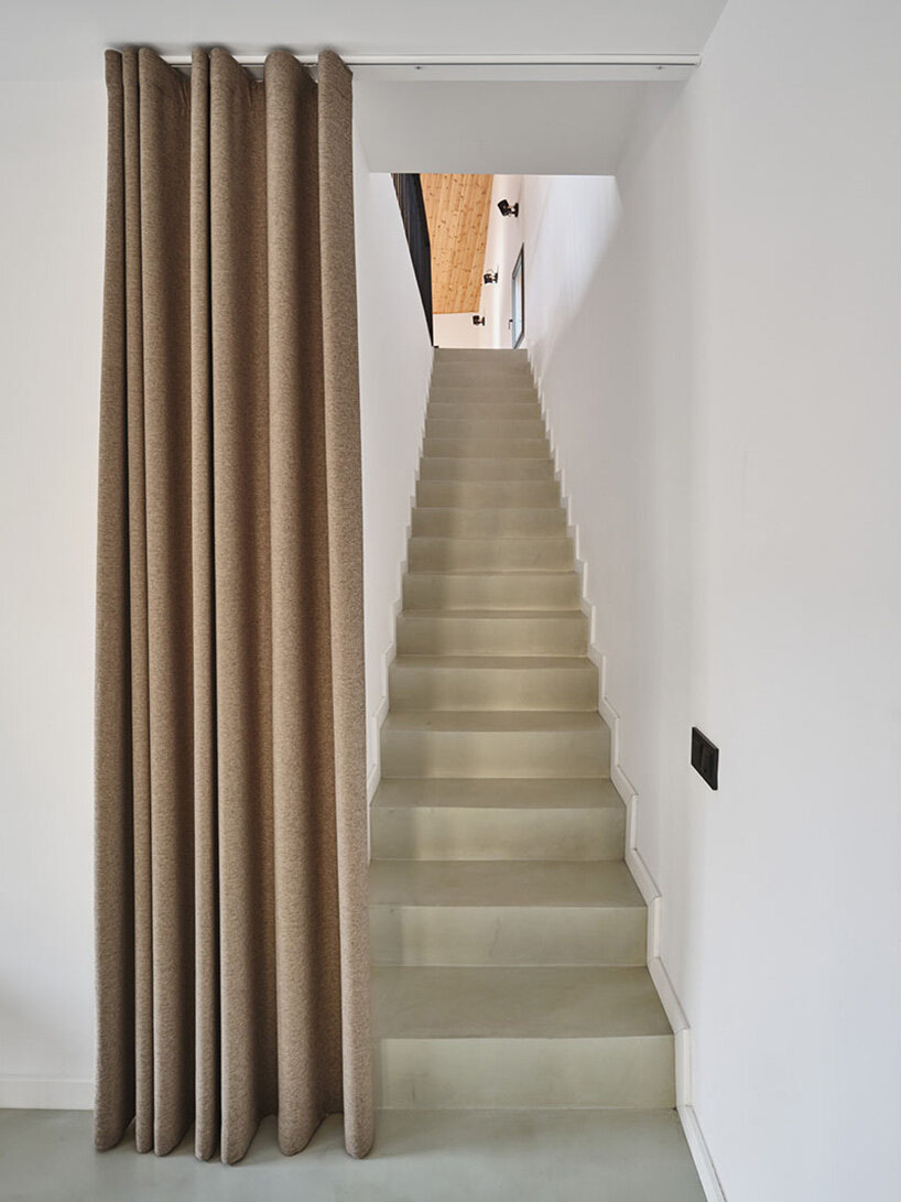 the upper level houses a bedroom, kitchen, and covered terrace