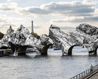 JR begins shaping stone-like cavern across paris' pont neuf, honoring christo & jeanne-claude