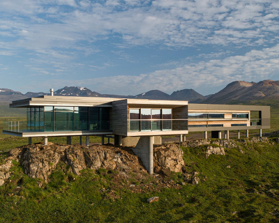 gudmundur jonsson's residence rests on columns along mountainous icelandic landscape