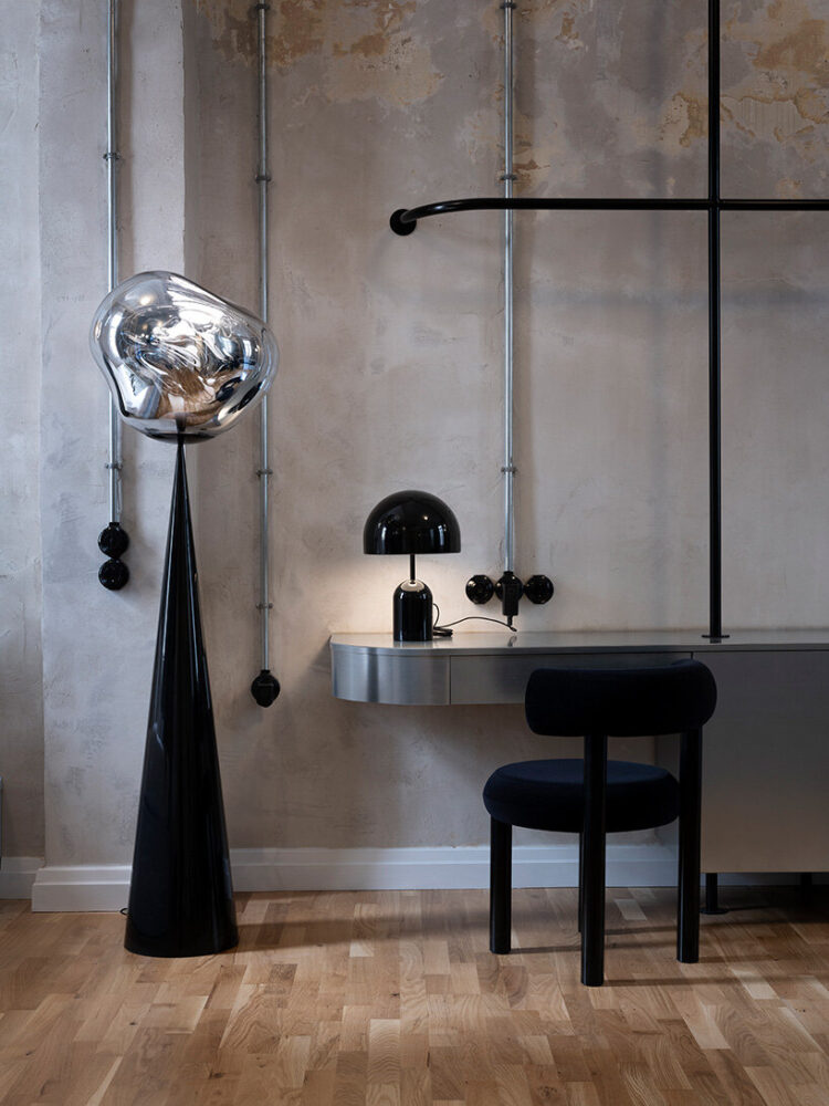 showcasing the signature industrial-chic aesthetic of Tom Dixon