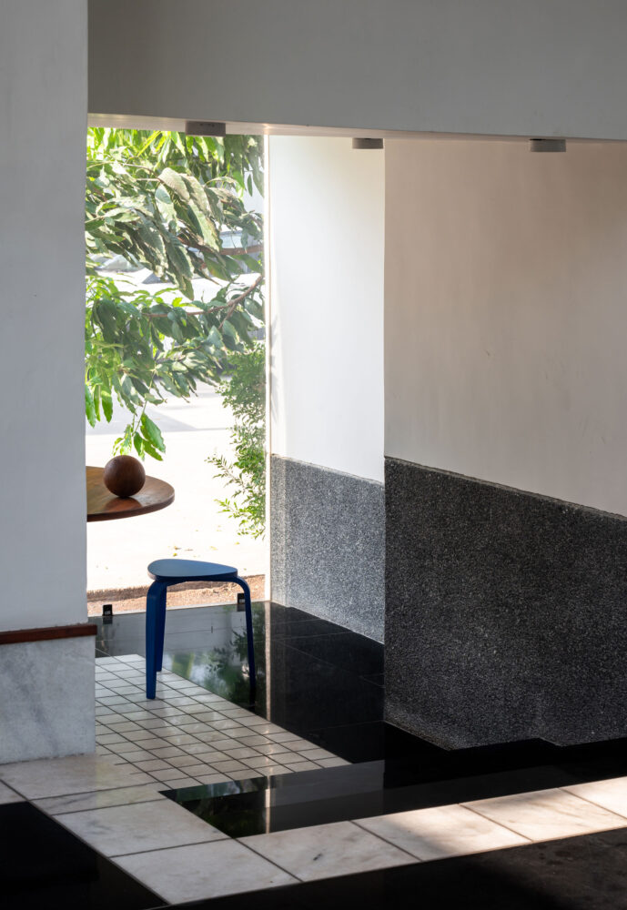 flooring choices, including black granite and checkered marble, introduce playful contrasts