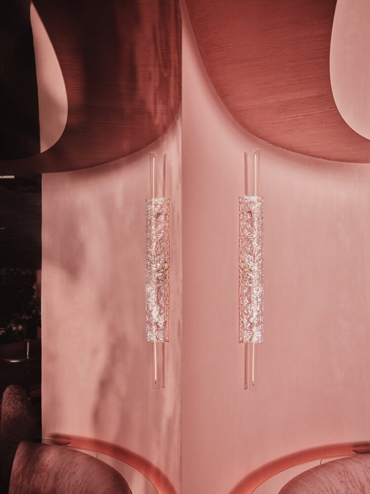 the color palette contrasts subtle fleshy tones with rich textures