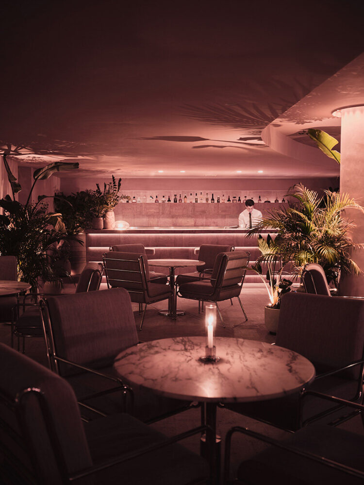 walls clad in peach terra cotta and travertine tiles arranged in a herringbone pattern