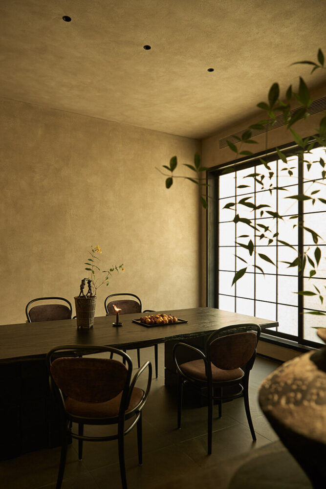 earth-toned walls are paired with dark furniture crafted from wood and stone