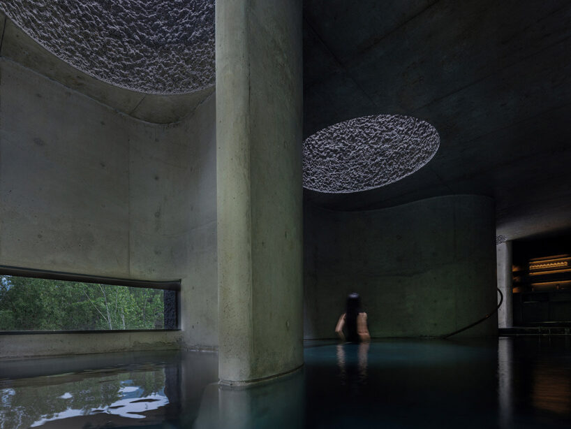 ribbon windows frame views of cliffs and treetops while bathing