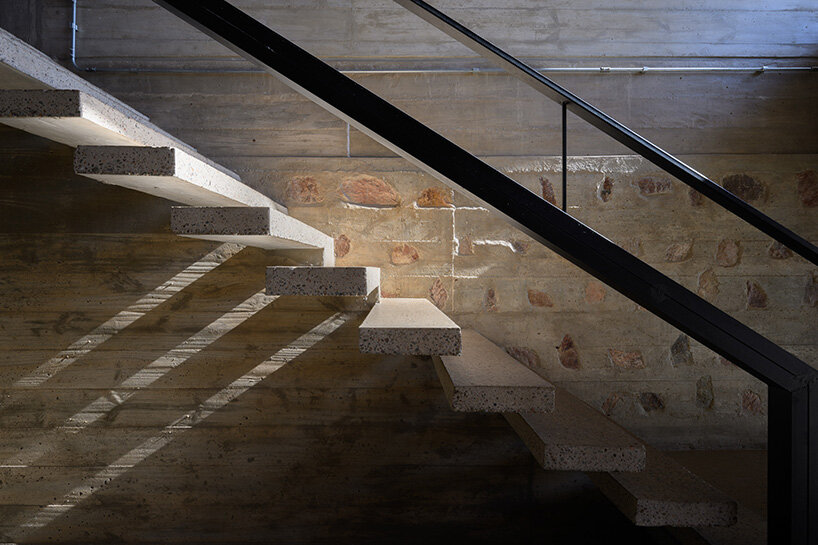 a staircase within this volume connects the upper and lower floors