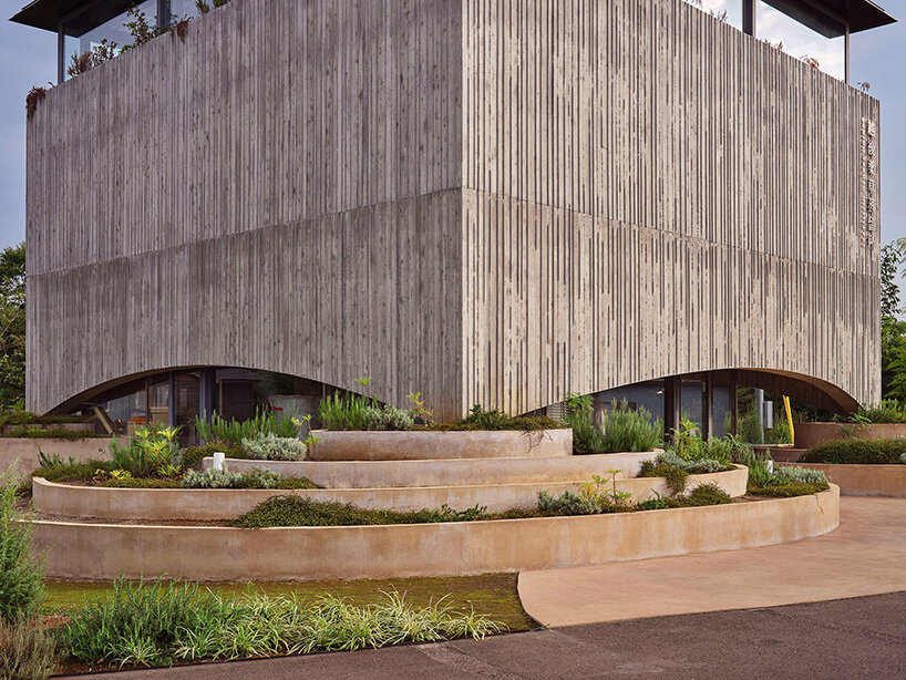 artificial terraces and pathways extend from the garden into the distillery