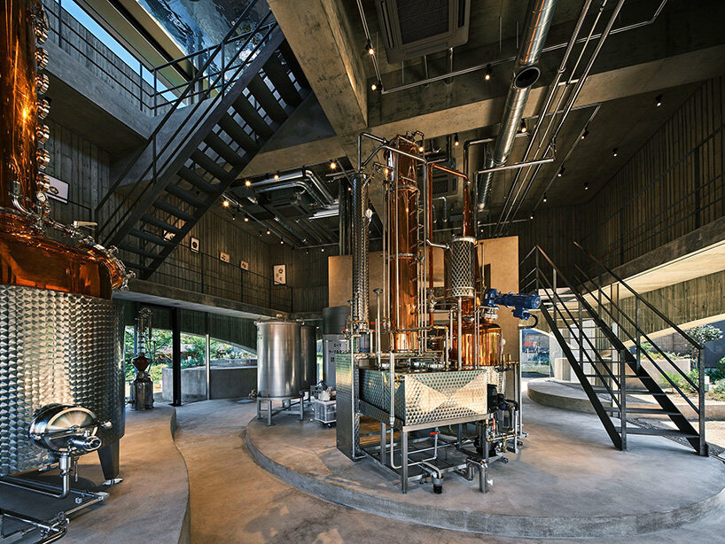 a cloistered gallery on the second floor wraps around the distillation equipment