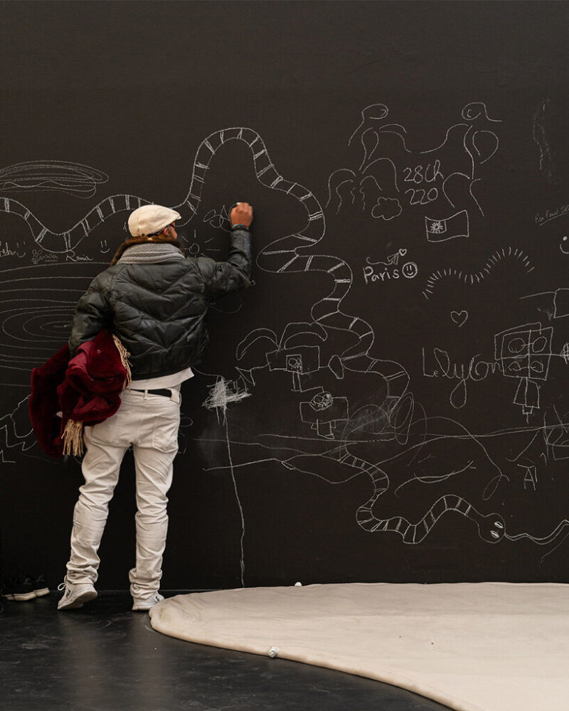 white paper and chalk are available for ephemeral visitor drawings on the walls.