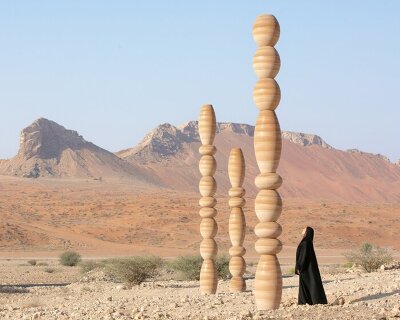 sculpted from sand, karim+elias' desert relics installation rises like ancient totems in UAE