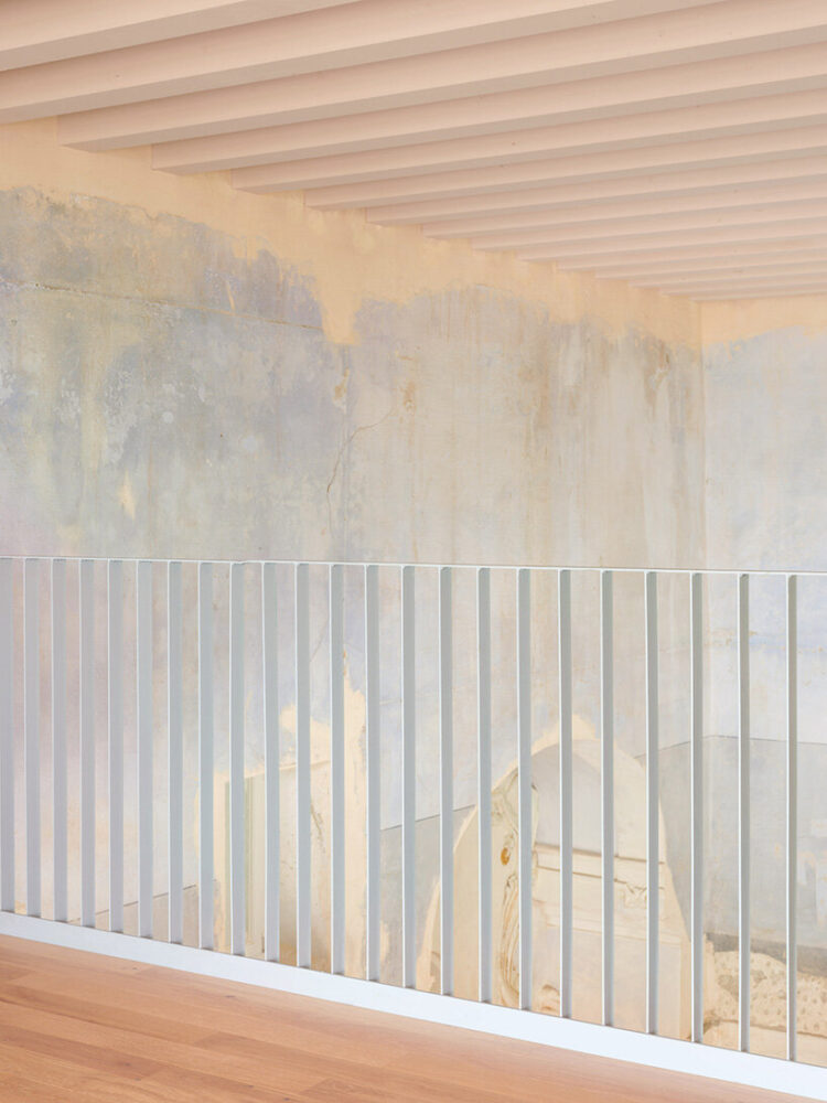 the upper floor provides an open space with panoramic views of the hall below