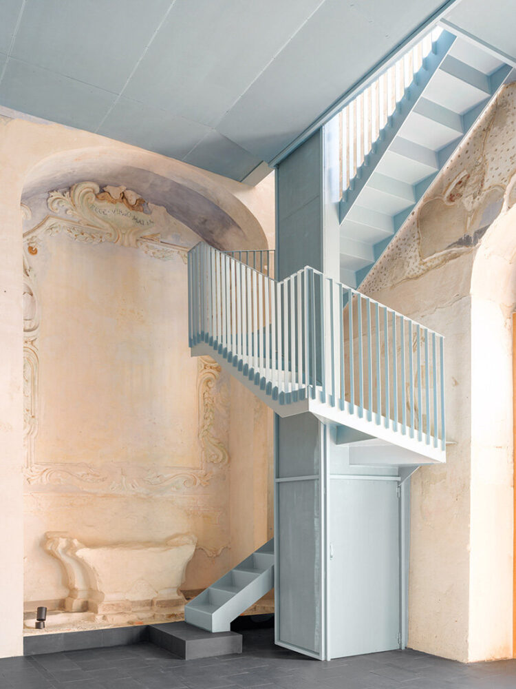 the staircase is clad in micro-perforated metal panels