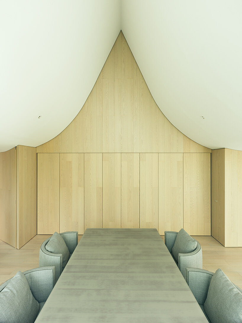 wood clads the walls inside the residence