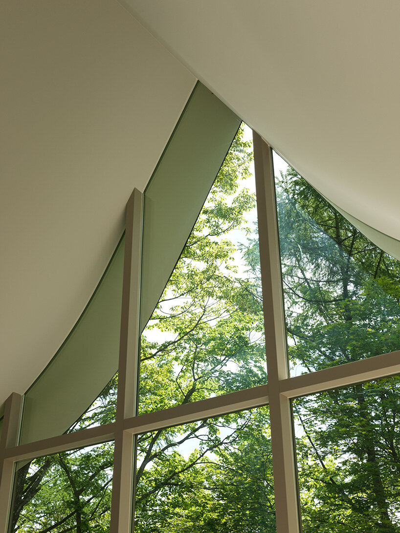 the glass openings follow the curves of the roof