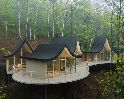 nendo weaves six cottages together with 'hand-holding' roofs in japanese forest house