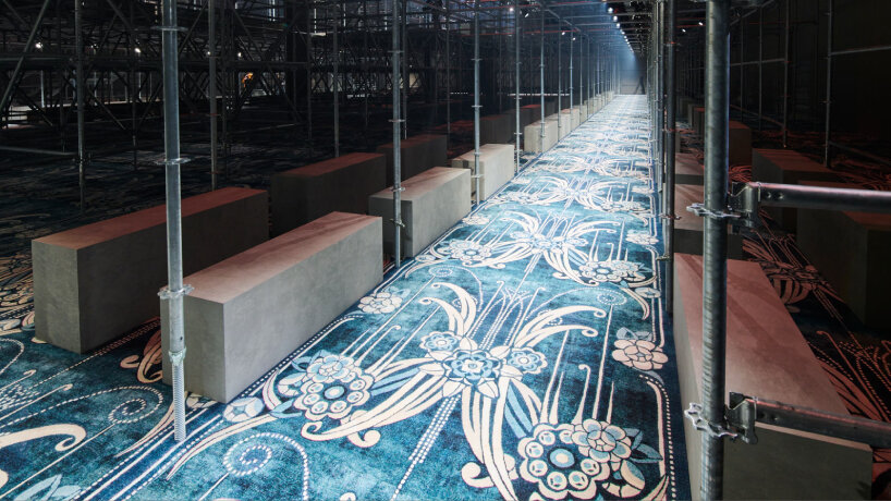 attendees to the show sit on concrete benches