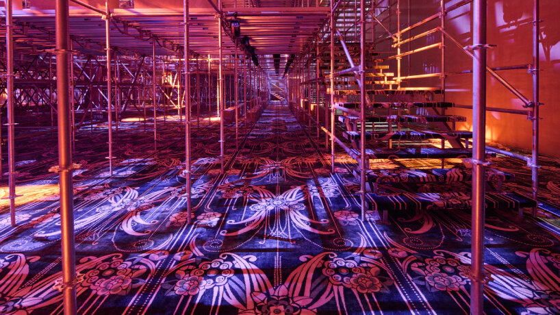 the floral-inspired carpet by Catherine Martin adds design details to the already vibrant set design