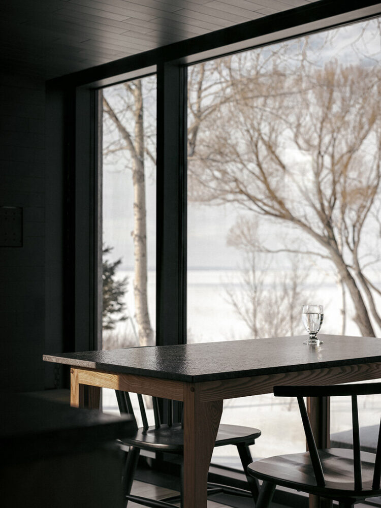 the central living area features expansive bay windows 