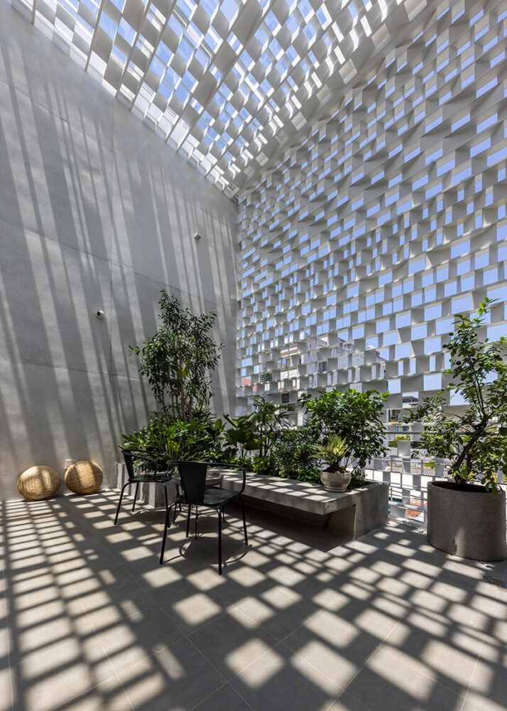 a soaring atrium, extending from the first floor to the roof, channels airflow through the home