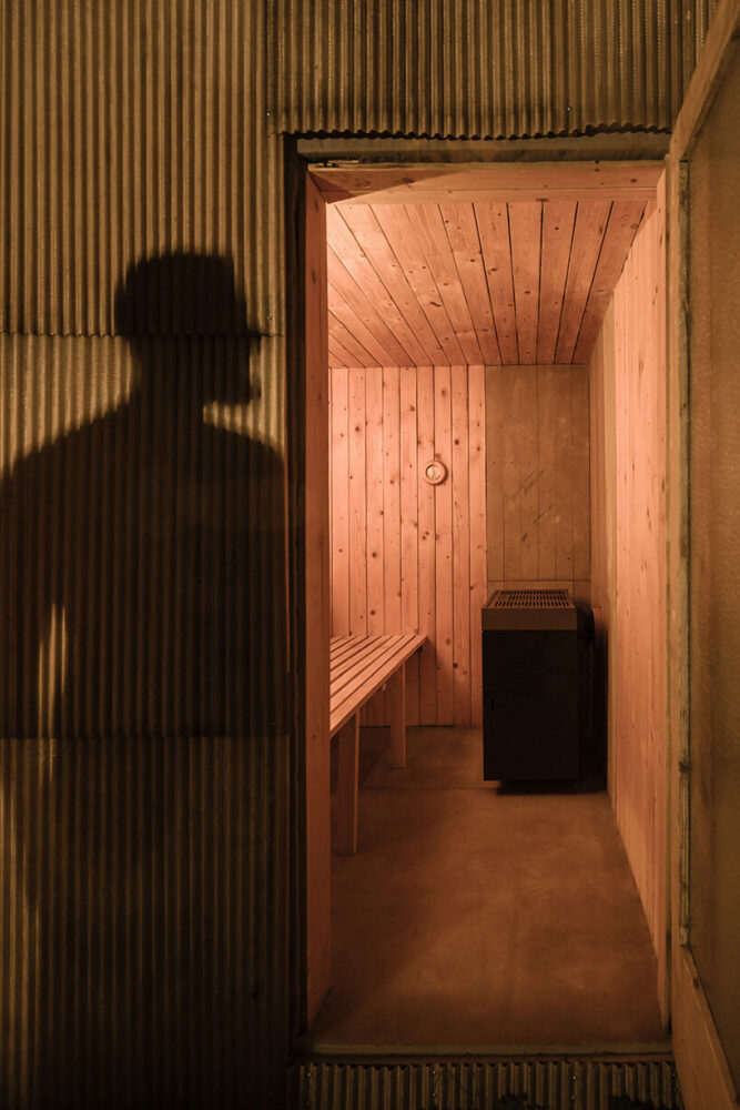 the sauna features wooden planks for a warm, natural aesthetic