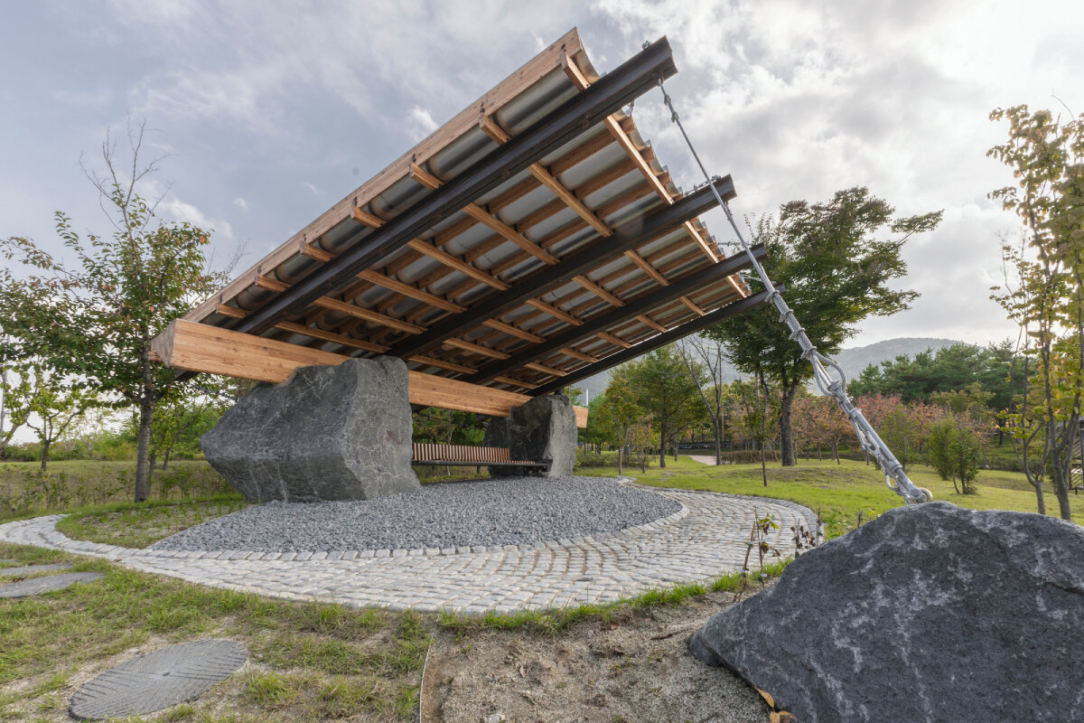 SO? rests wood & metal canopy atop rocks for 'urban interior' pavilion in south korea