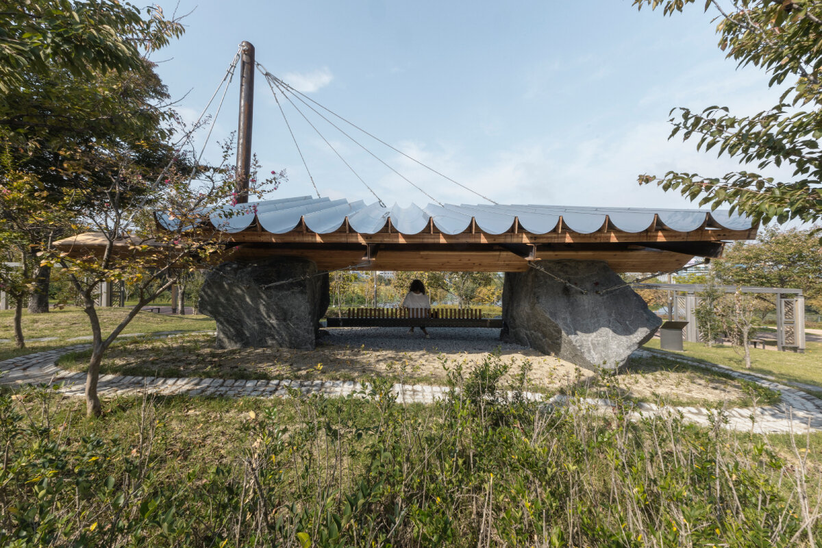 SO? rests wood & metal canopy atop rocks for 'urban interior' pavilion in south korea