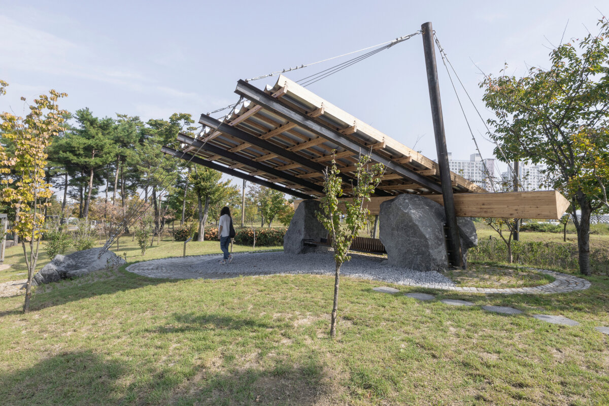 SO? rests wood & metal canopy atop rocks for 'urban interior' pavilion in south korea