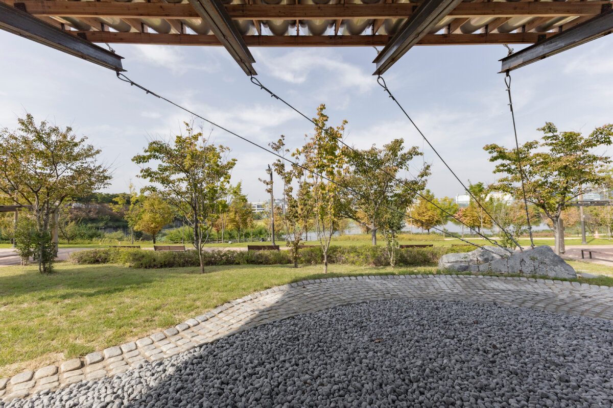 SO? rests wood & metal canopy atop rocks for 'urban interior' pavilion in south korea