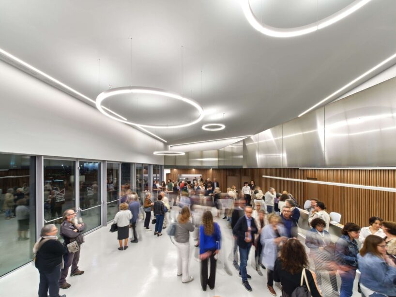 interior features include wooden acoustic panels, dark grey plaster, and resin floors