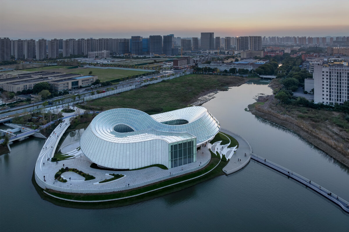 translucent interlocked rings shape aedas' jade-like yohoo museum in china