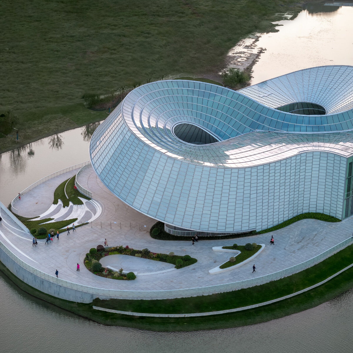 translucent interlocked rings shape aedas' jade-like yohoo museum in china