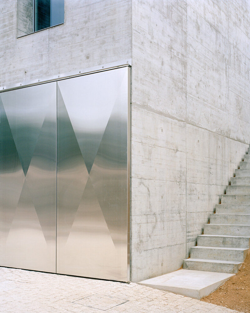 concrete, stainless steel, glass and ceramic tiles compose the materiality of the exterior