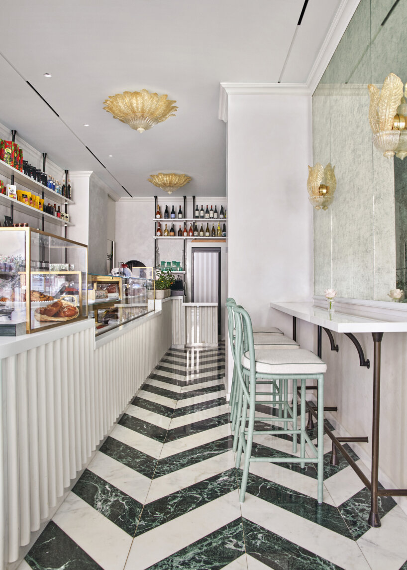 the interior designs include the banquette wrapped with 18th-century wallpaper