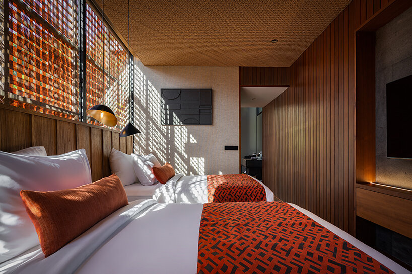 dramatic shadows cast by the woven facade panels, adding depth and intrigue