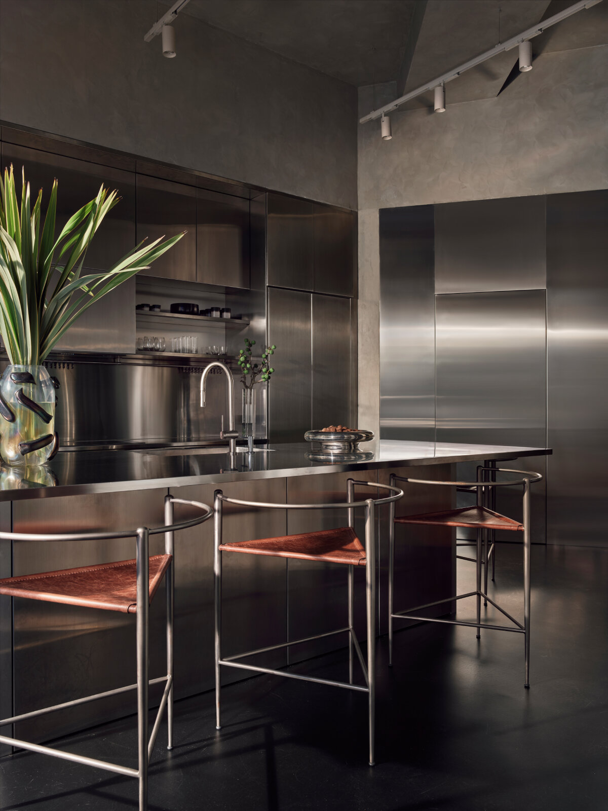 SANAYI313 finishes actress' house in istanbul with industrial accents, organic textures, and sculptural fixtures