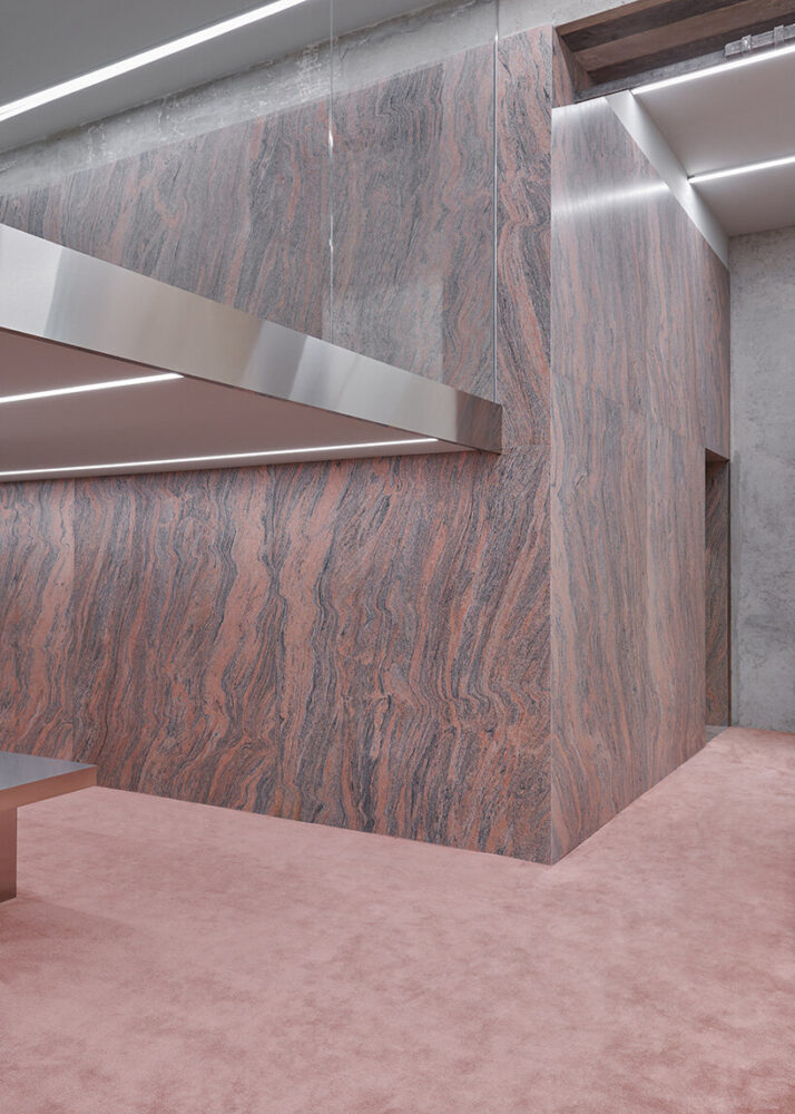 the designers intergrate the mechanical systems of the showroom within stainless steel columns