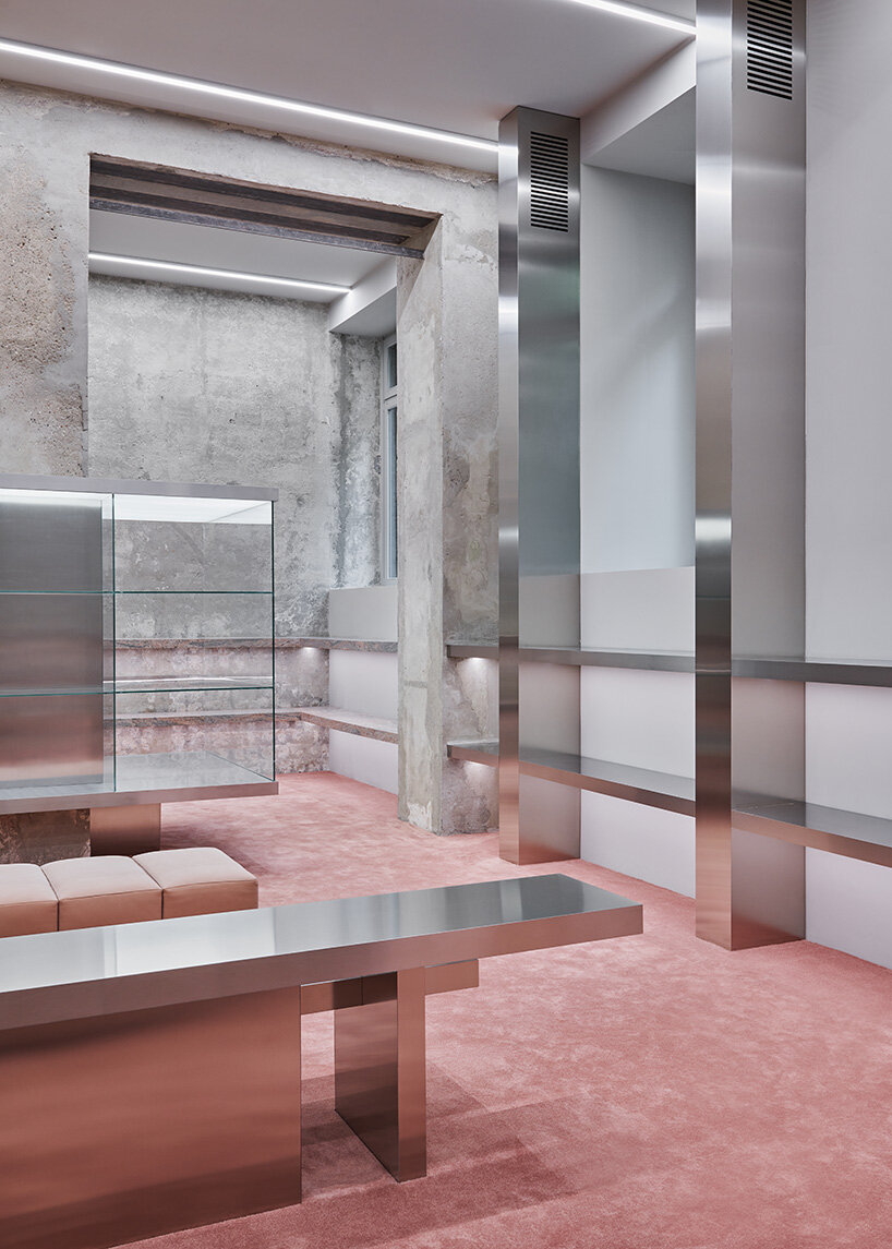 stainless steel columns mark different sections of the displayed collections