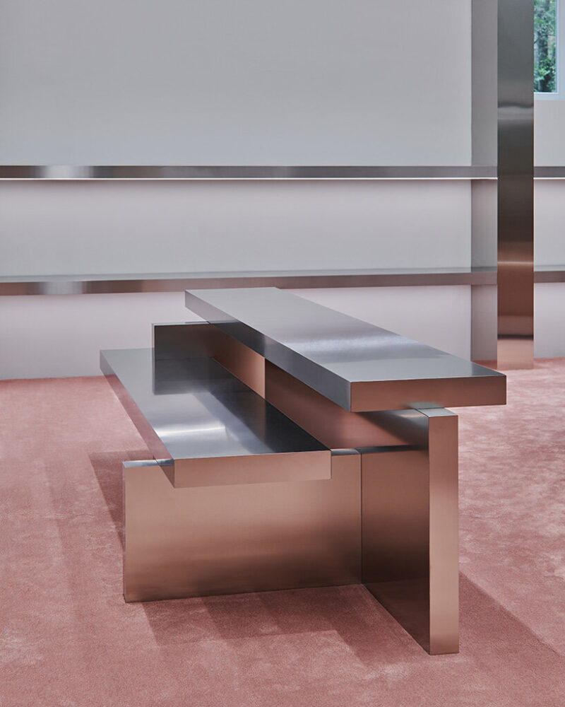 sleek bespoke furniture reflects the pink hues of the flooring